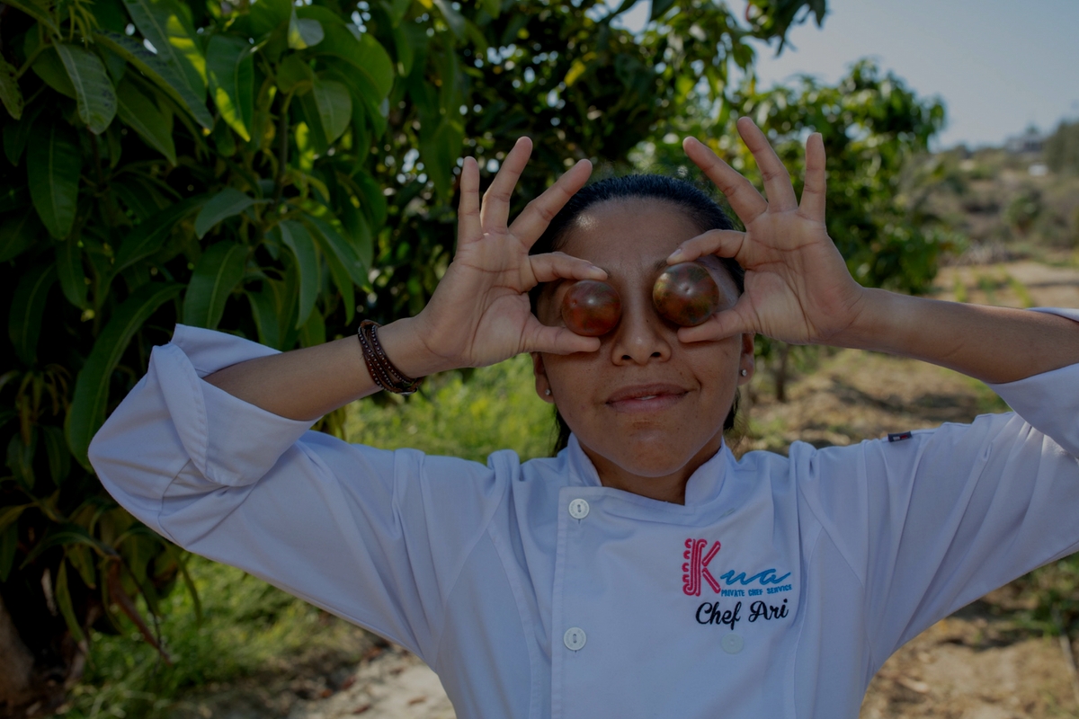 Chef Ari holding Tomatoes over her eyes