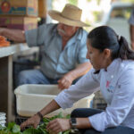 Chef Ari buying organic vegetables from her farmer.